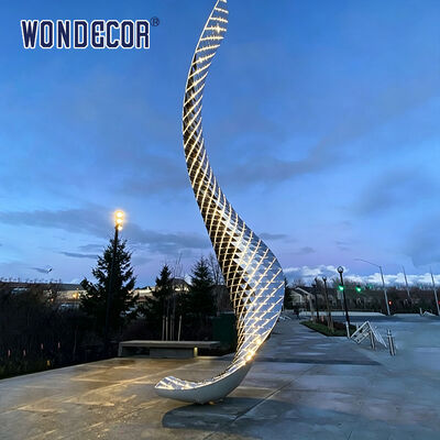 Large outdoor stainless steel lighting sculpture with curved shape