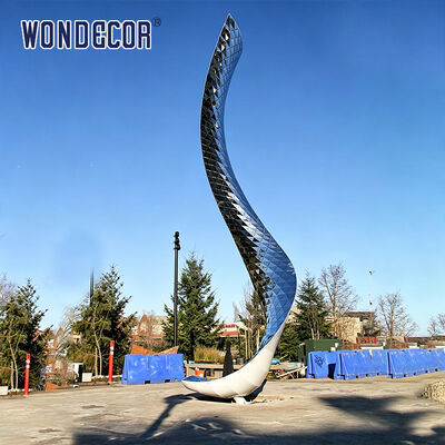 Large outdoor stainless steel lighting sculpture with curved shape